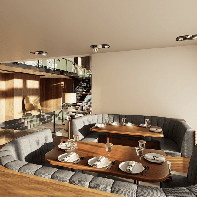 The warm, modern dining room at Savora — wooden tables, soft lighting, and a mix of couples and small groups settled in for a meal, the room full but unhurried